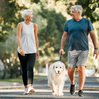 couple walking dog